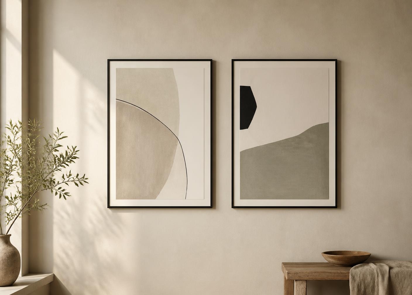 Two thin-framed minimal prints hung side by side on a warm ivory wall